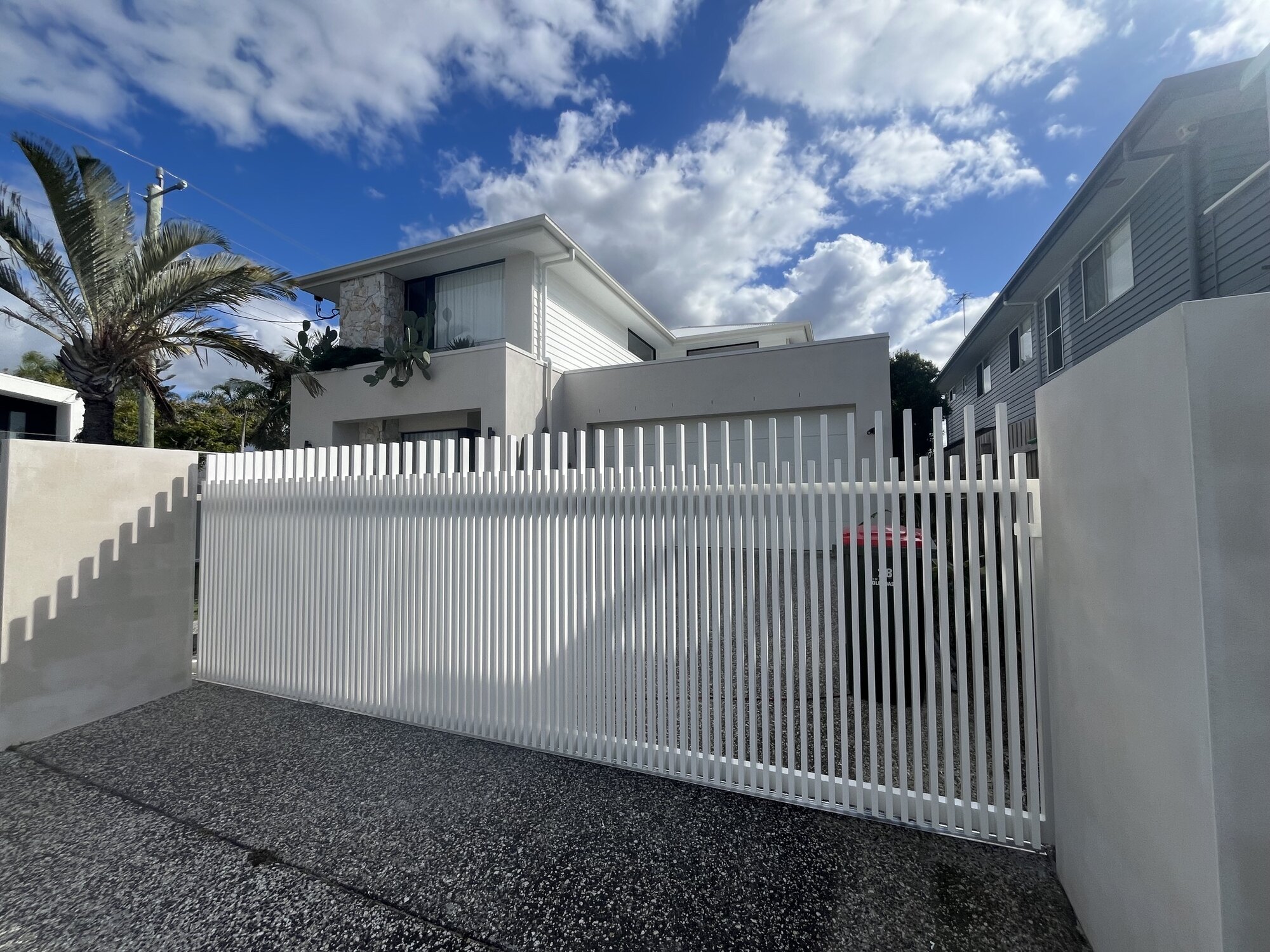 Custom white aluminium sliding gate built by MetalTek on the Gold Coast